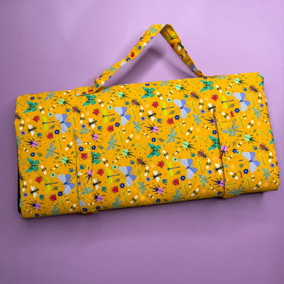 Yellow quilt with colorful patterns on a purple background