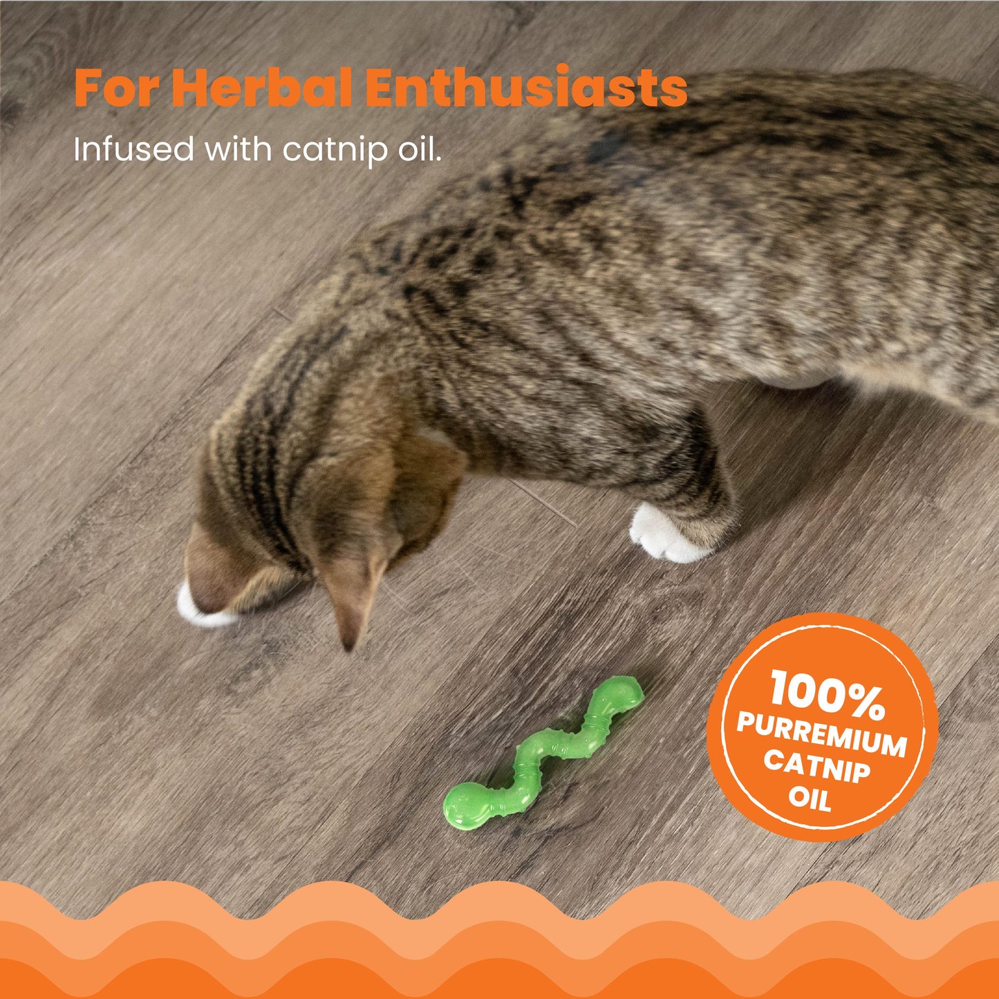 Cat playing with a green catnip toy on a wooden floor, with text about catnip oil.