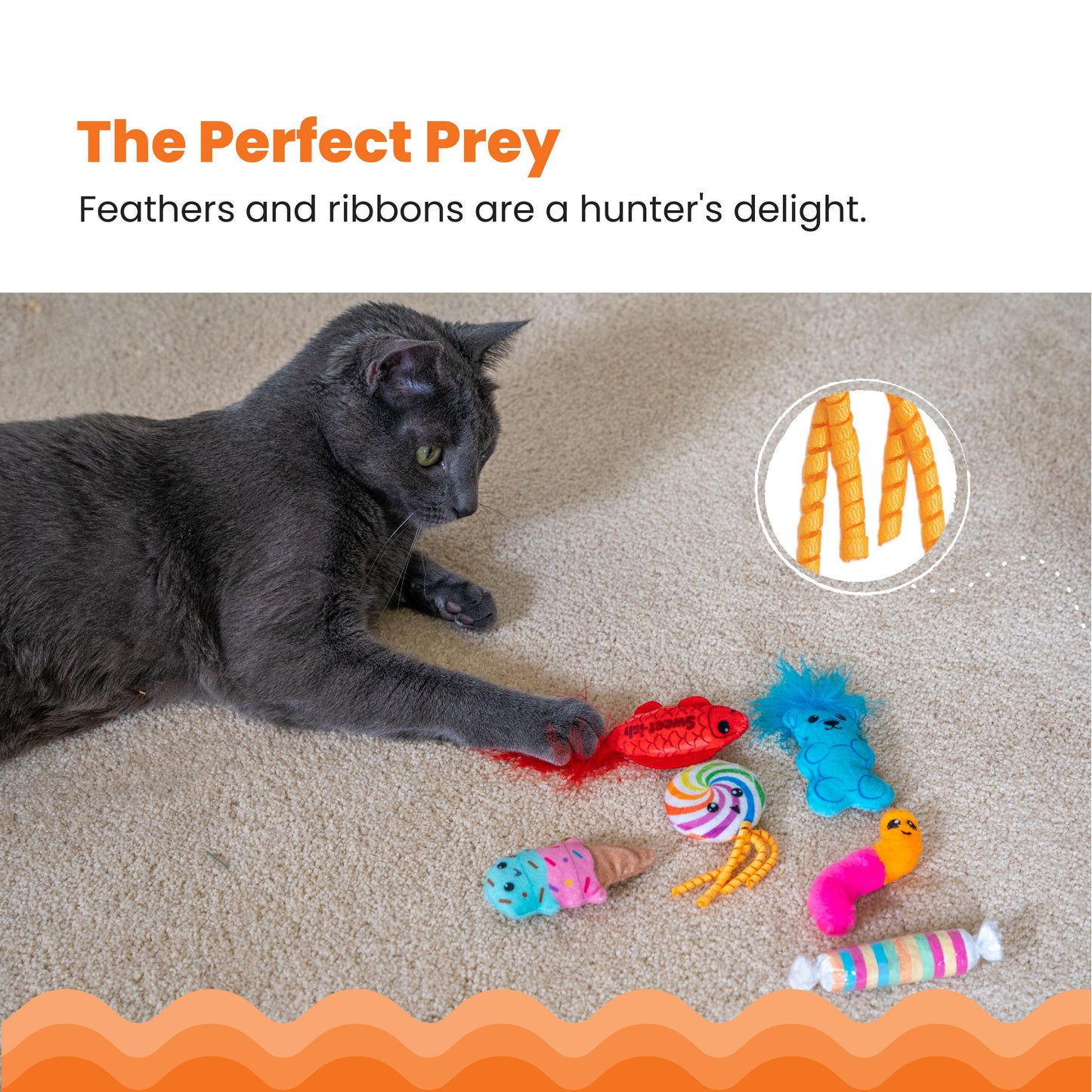 Cat playing with colorful cat toys on a carpet, with text 'The Perfect Prey' and 'Feathers and ribbons are a hunter's delight.'.