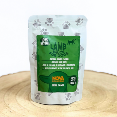 Nova Lamb Sauce for Dogs on a wooden tray against a white background