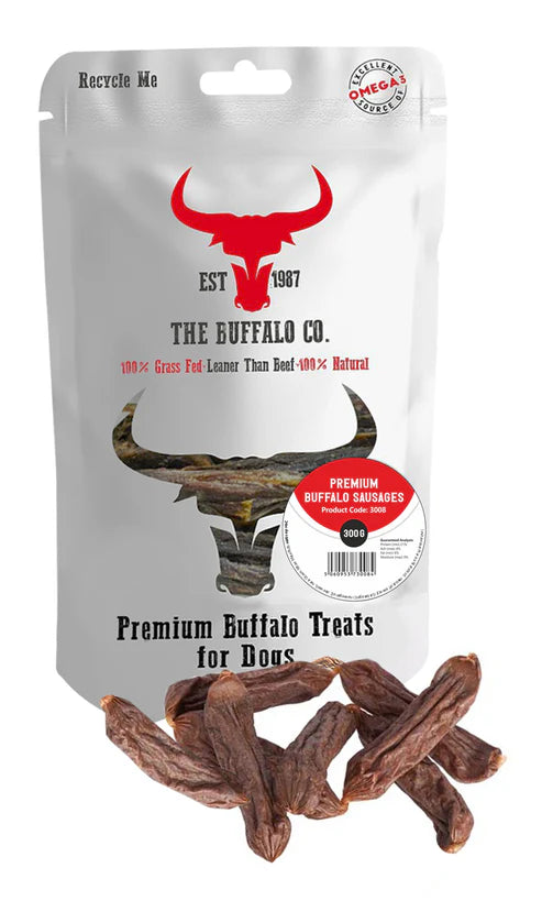 Packaging of Premium Buffalo Sausage dog treats featuring the brand 'The Gourmet Buffalo Co.' with a picture of buffaloes in the background and a pile of sausages in front, indicating the product is for dogs.
