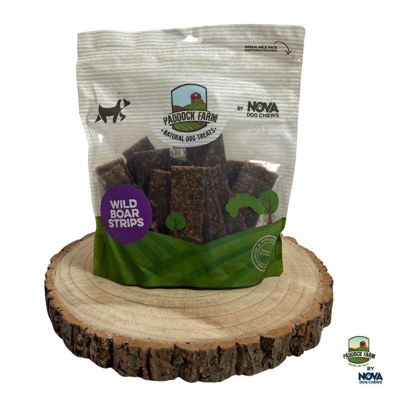 Bag of Paddock Farm Wild Boar Strips natural dog treats displayed on rustic wood slice, single-protein, hypoallergenic chew option for sensitive dogs, stocked by Amyβs Pet Supplies.