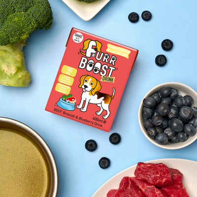 A packaged Furr Boost Smoothie Drink for Dogs with illustrations of a dog and a cat, alongside bowls of beef, broccoli, and blueberries.