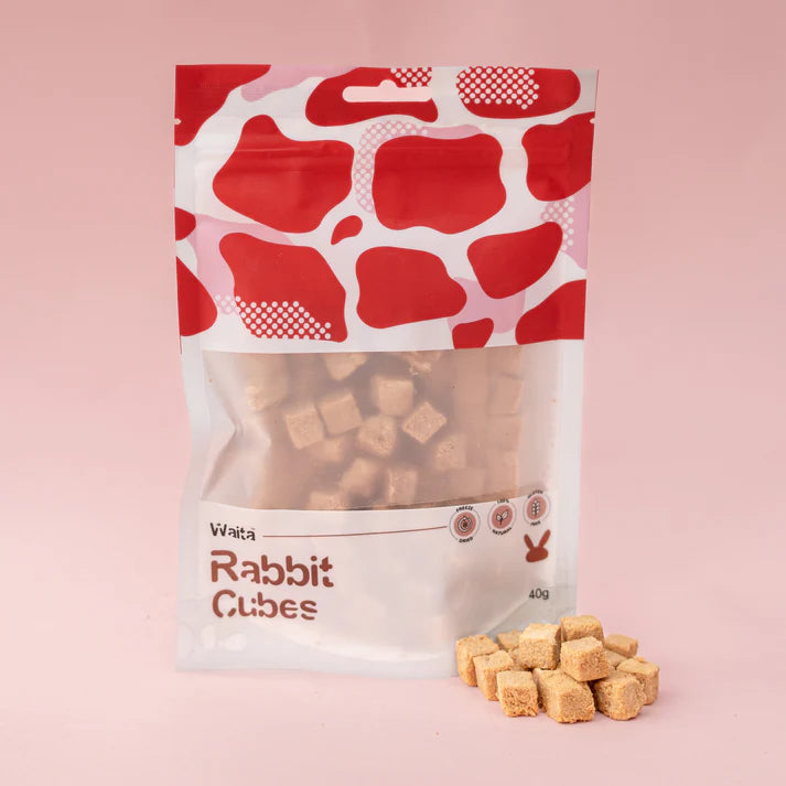 Package of Waita Rabbit Cubes with visible rabbit cubes on a pink background