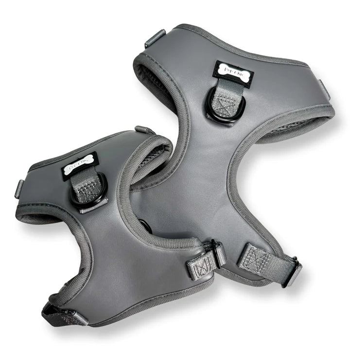 Two gray dog harnesses on a white background