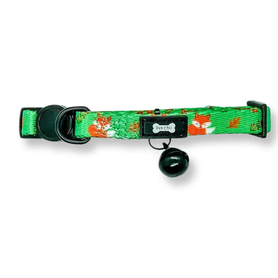 Green cat collar with floral pattern and black bell on a white background