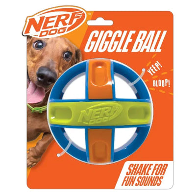 Nerf Dog Giggle Ball toy in its original packaging, featuring bright blue, orange and green colours with “shake for fun sounds” printed on the label and a cartoon-style dachshund in the background.