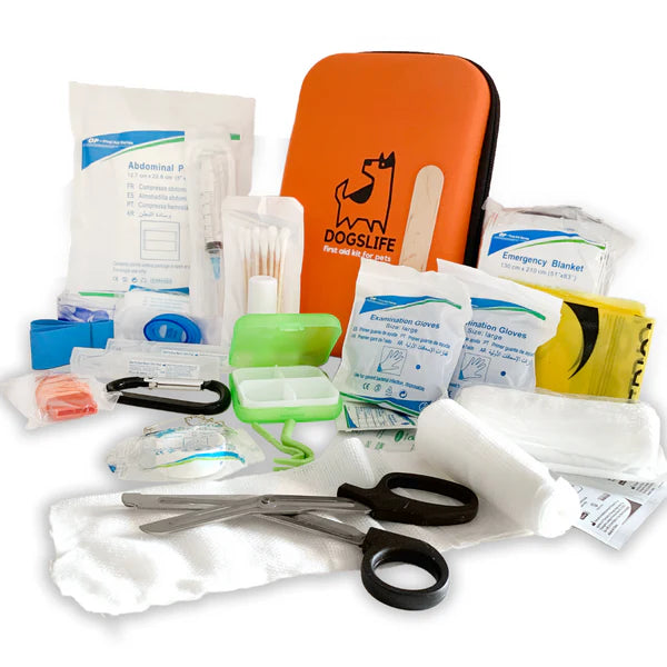 Complete DogsLife pet first aid kit displayed with all included items: bandages, scissors, gloves, gauze, tweezers, emergency blanket, wound dressings, and medicine box – perfect emergency care for dogs and cats at home or while travelling