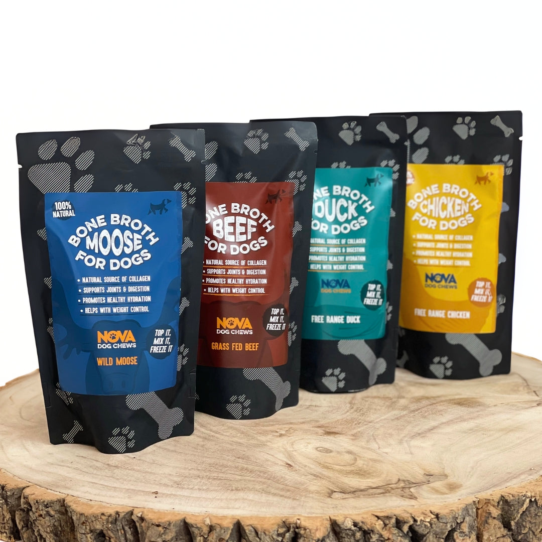 Four Nova Pet Food packages for dogs on a wooden surface