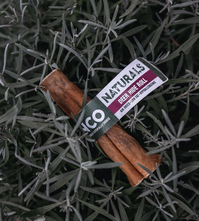 Deer hide roll with a label on a bed of green leaves