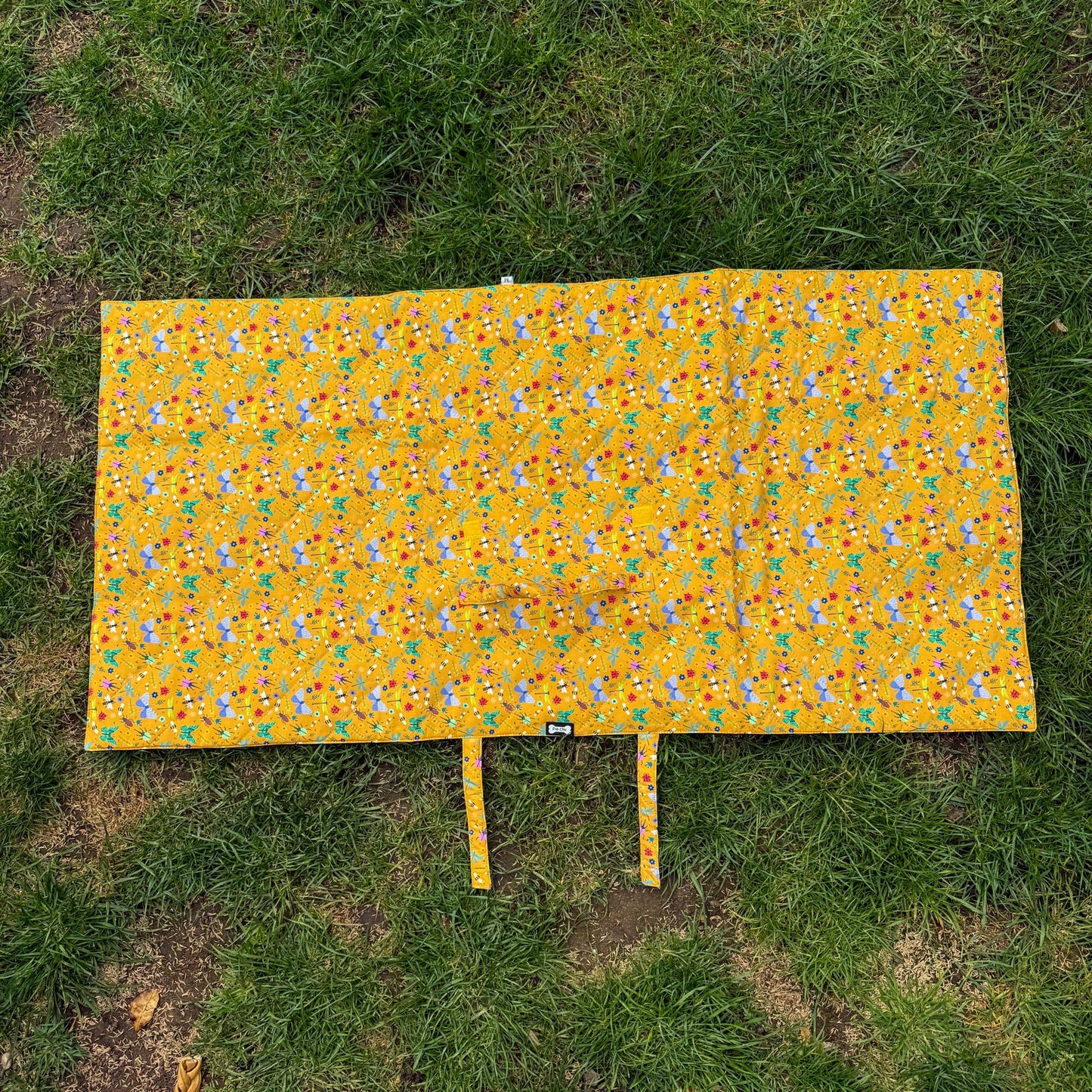 Yellow patterned blanket on grass