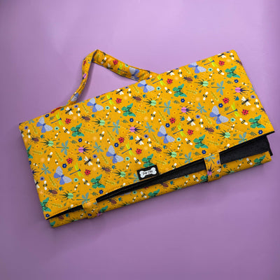 Folded Summer Buzzin’ Dog Settle Mat showing carry handle and compact size.