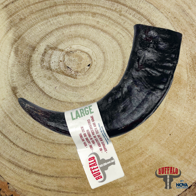 Large buffalo horn dog chew on rustic wooden background, 100% natural long-lasting chew for strong chewers, supports dental health and enrichment, available at Amy’s Pet Supplies.