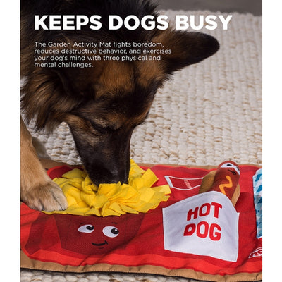 Dog playing with a toy on a mat labeled 'Hot Dog' with text about keeping dogs busy.