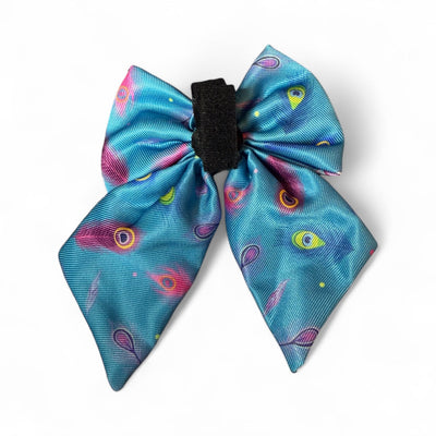 Blue bow with colorful eye pattern on a white background