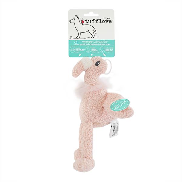 Pink plush dog toy with packaging on a white background