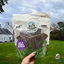 Paddock Farm Wild Boar Strips dog treats in resealable pouch, held in front of a countryside setting, high-protein grain-free chews made from 100% wild boar, available at Amy’s Pet Supplies.
