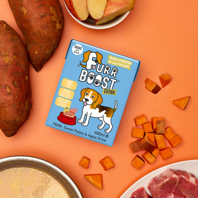 Furr Boost drink package with sweet potatoes, apples, and meat on an orange background