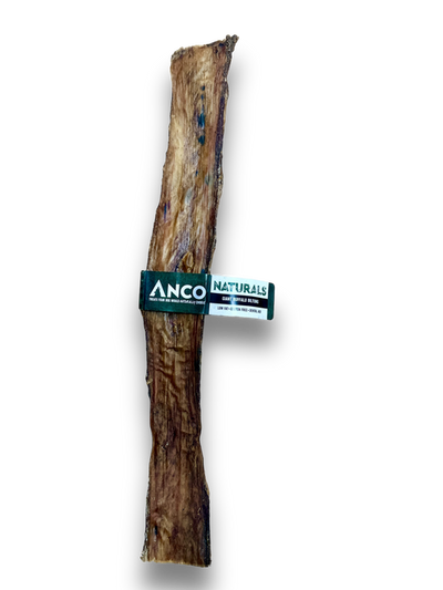 Single, extra-long Anco Naturals Giant Buffalo Biltong chew stick on black background, showing natural texture and branded label