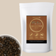 Bag of Dog & Cat Blakes Digestive Treats with a bowl of pet food on a beige background