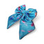 Turquoise bow with peacock feather pattern on a white background
