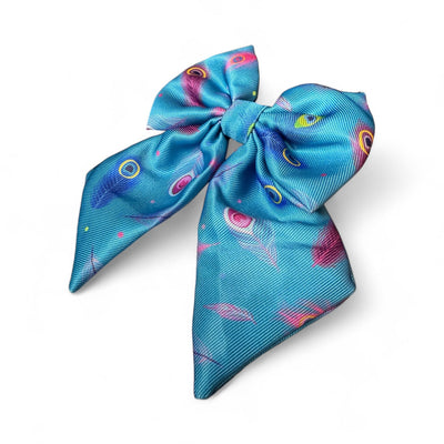 Turquoise bow with peacock feather pattern on a white background