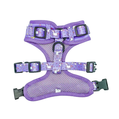Purple dog harness with cartoon designs on a light purple background