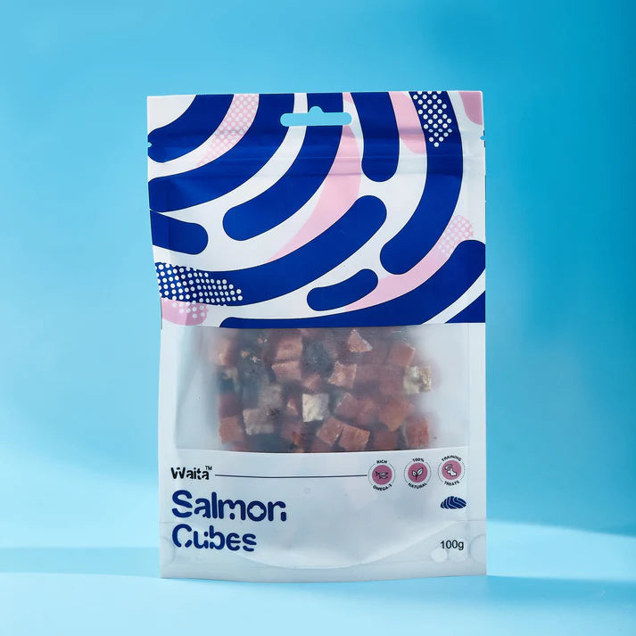 Packaged salmon cubes with blue and white pattern on a blue background