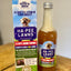 Woof & Brew Ha-Pee Lawns herbal tonic bottle and packaging displayed on wooden surface, promoting natural solution to prevent dog urine burns on lawns and support canine health
