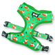 Green dog harness with orange fox pattern on a white background