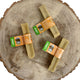 Large peanut-butter Yak Snack dog chews on wooden surface