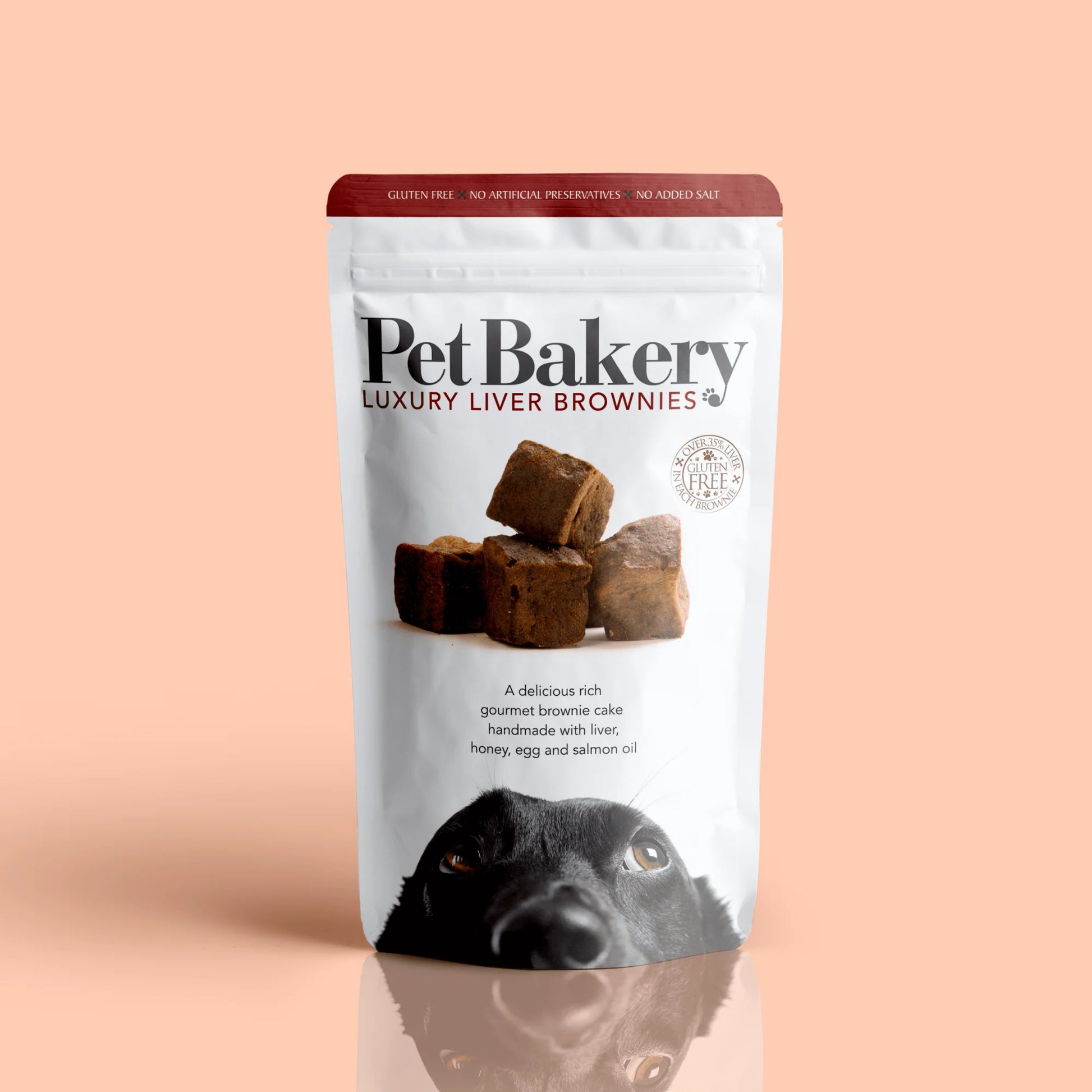 Pet Bakery Luxury Liver Brownies dog treats in white resealable pouch with bold branding and a playful black dog illustration on the front. Gluten-free, preservative-free, and made with liver, honey, egg, and salmon oil.