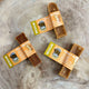 Medium peanut-butter Yak Snack dog chews on wooden surface