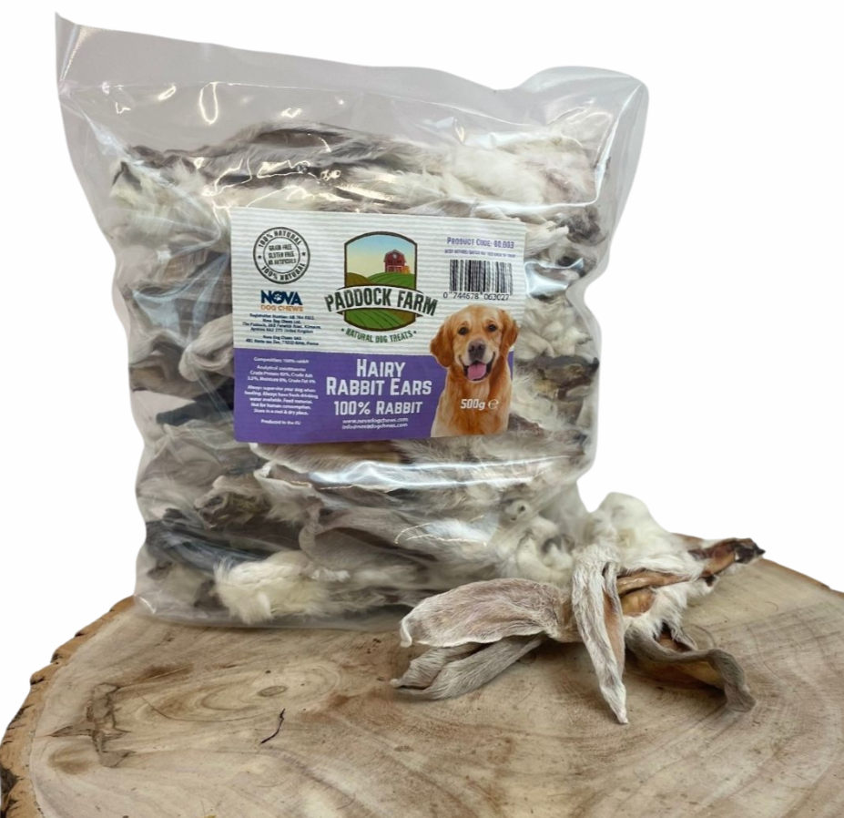 500g bag of Paddock Farm Hairy Rabbit Ears dog treats, 100% natural rabbit, shown with loose ears on a wooden surface for display