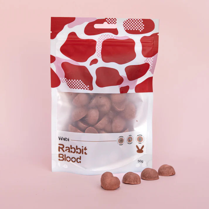 Packaging of 'Rabbit Blood' treats with a red and white pattern on a pink background