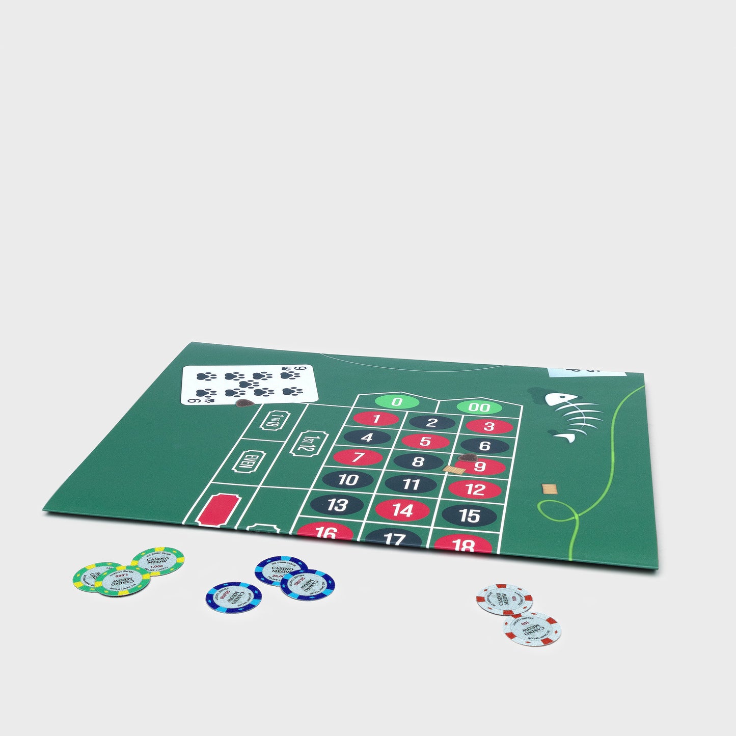 Flat-packed roulette wheel cat toy with fold-out mat, bell ball, and cardboard casino chips for playful assembly.

