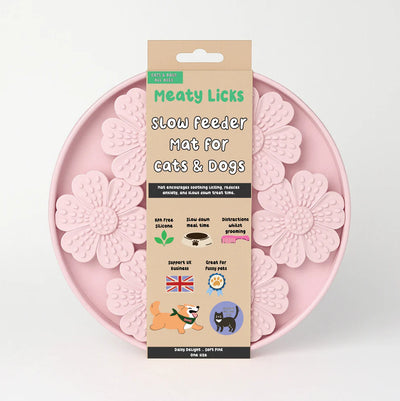 Pink slow feeder mat for cats and dogs with packaging on a light gray background