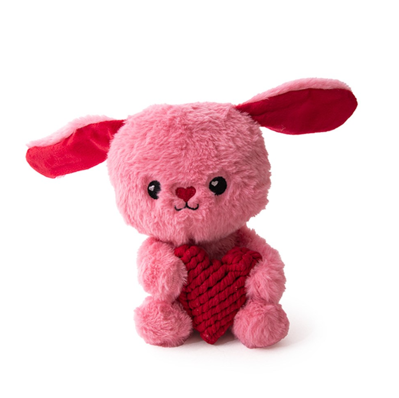 Pink Rabbit shaped plush toy with red heart and ears designeged for dogs  on a white background