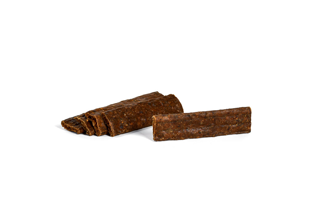 Close-up of Paddock Farm venison dog chew strips, dark brown textured treats made with single-source protein, perfect for dogs with sensitivities, available from Amy’s Pet Supplies.