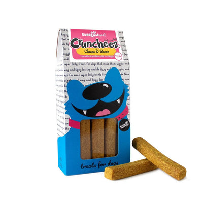 Supernature Cruncheez Cheese & Bacon dog treats in fun illustrated box with two hand baked biscuit batons displayed beside the packaging
