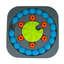 Örva Puzzle Wheel dog enrichment toy with grey base, blue treat covers, orange pieces and green centre
