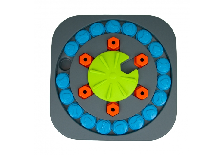Örva Puzzle Wheel dog enrichment toy with grey base, blue treat covers, orange pieces and green centre