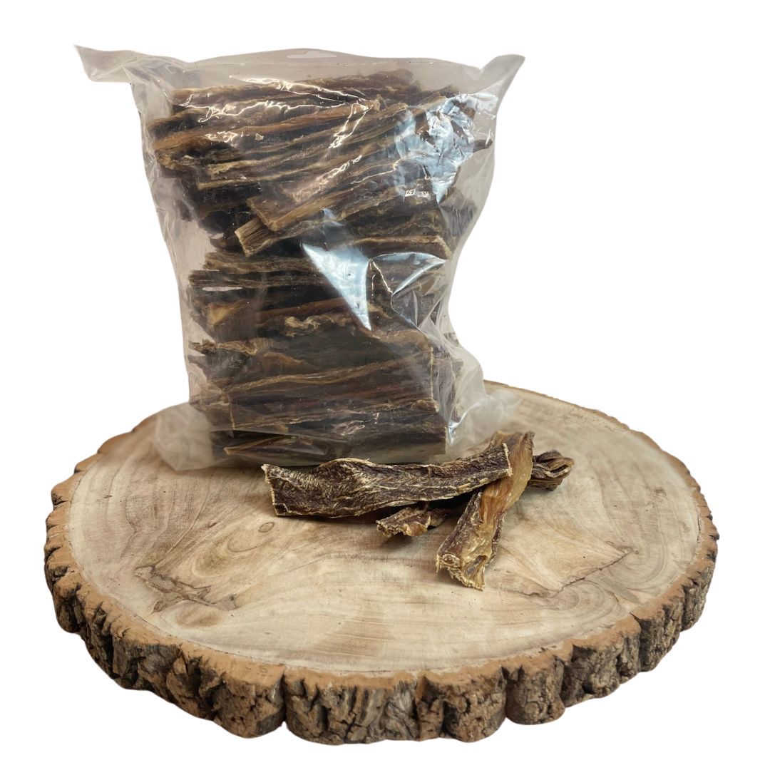 Paddock Farm Buffalo Flat Gullet 1kg bag with natural flat chew strips displayed on a wooden board