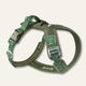 Twiggy Tags Apex Nomad dog harness with green contour-pattern straps, olive padding, reflective trim, clip buckles and a padded back handle.