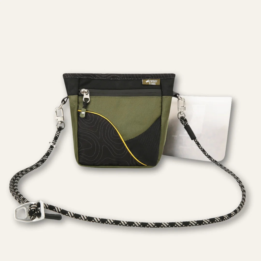 Twiggy Tags Crosslander Tundra treat pouch in olive green and black with contour pattern and yellow trim, shown with an adjustable strap and white silicone insert.