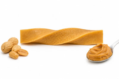Peanut butter with a spoonful, a block, and peanuts on a white background