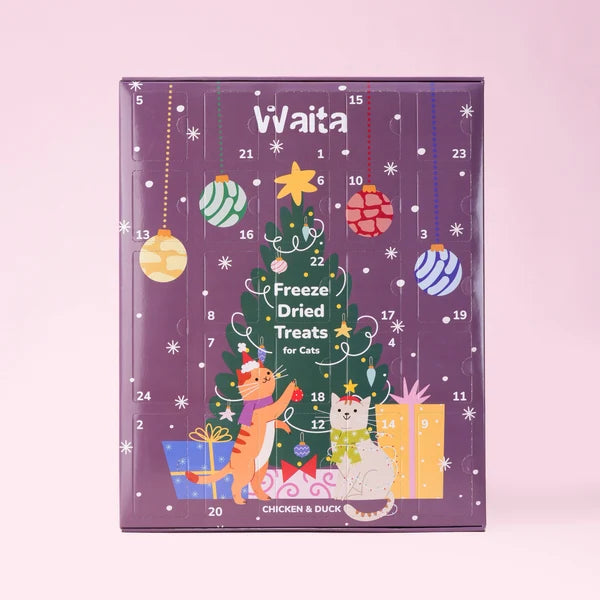 Waita Freeze-Dried Christmas Advent Calendar for cats, showing a purple box with 24 numbered doors, a Christmas tree, cats and gifts on a pink background.