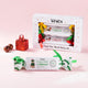 Waita Christmas Cracker Gift Box with wrapped lollipop crackers and coloured ribbons, plus a green cracker displayed in front on a pink background.
