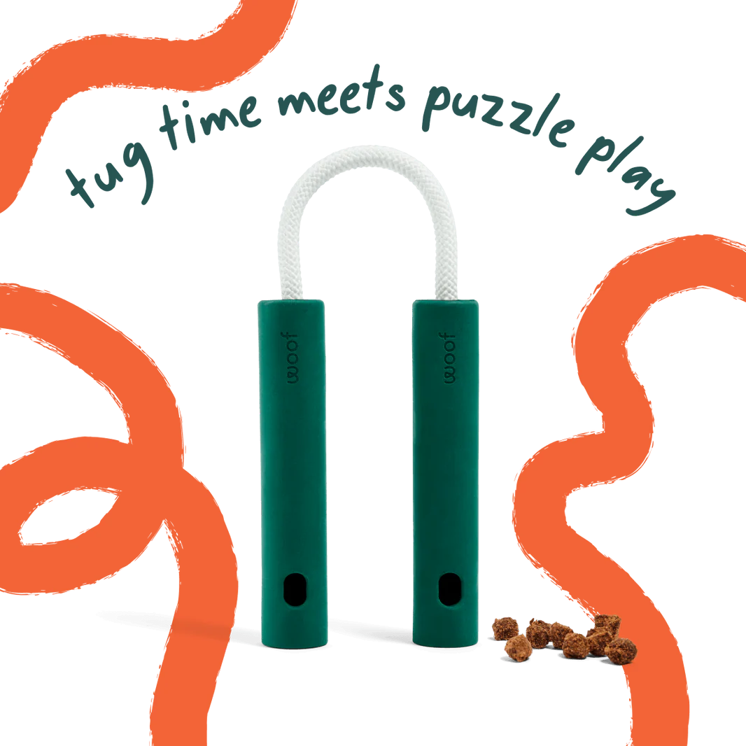 Woof Nomchucks green dog tug and treat puzzle toy with rubber handles and connecting rope