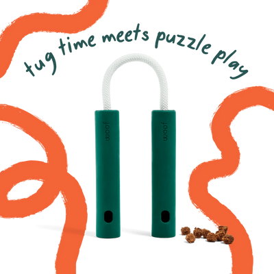 Woof Nomchucks green dog tug and treat puzzle toy with rubber handles and connecting rope